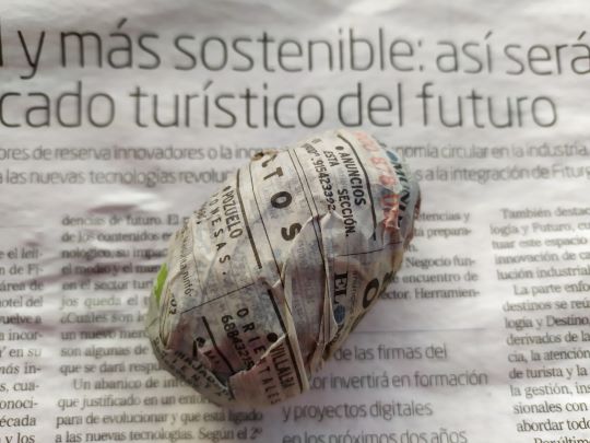 Primer paso para decorar huevos de pascua: en la foto el huevo envuelto en un papel de periódico