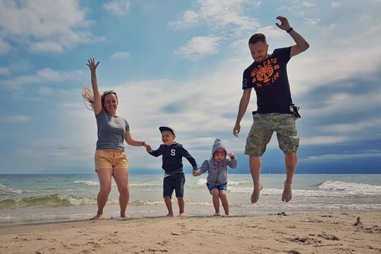 Famiglia che salta sulla spiaggia